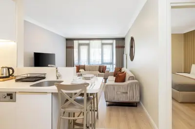 a kitchen and living room with a table and chairs at Mayar Residence Hotel in Istanbul