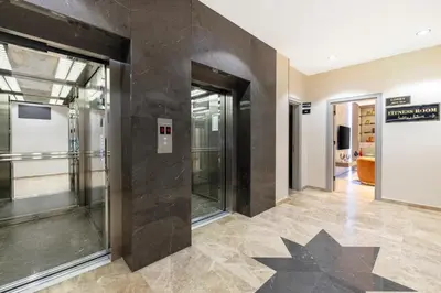 a hallway with glass doors and tile floors at Mayar Residence Hotel in Istanbul