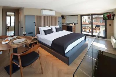 a bedroom with a bed and a table and a kitchen at CASA GALATA 35 in Istanbul