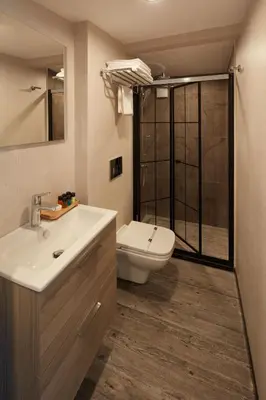 a bathroom with a white sink and a toilet at CASA GALATA 35 in Istanbul