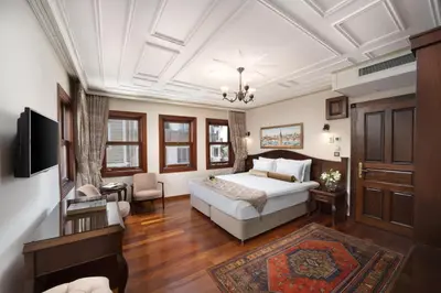 a bedroom with a bed and a living room at Bender Hotel in Istanbul