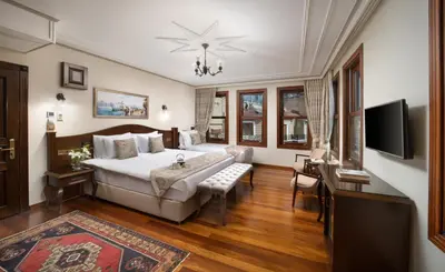 a hotel room with a bed and a tv at Bender Hotel in Istanbul