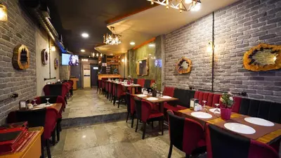 a restaurant with tables and chairs and a brick wall at Fidan City Hotel in Istanbul