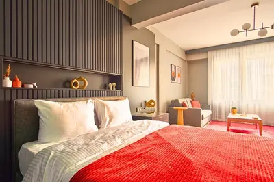 a bedroom with a bed with a red blanket at TAKS-INN Hotel in Istanbul