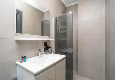 a bathroom with a white sink and a shower at Center Suite in Istanbul