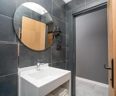 a bathroom with a white sink and a mirror at Center Suite in Istanbul
