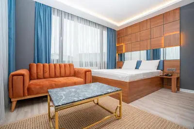 a hotel room with a bed and a couch at Center Suite in Istanbul