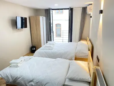 a hotel room with two beds and a tv at La Perato in Istanbul
