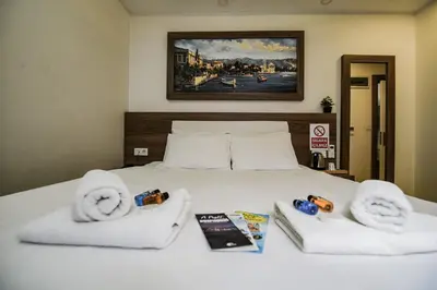 a bedroom with a bed with towels and magazines at MITANI SUITES in Istanbul