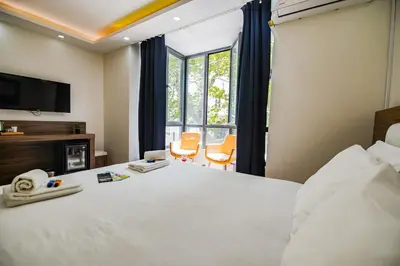 a hotel room with a bed and a tv at MITANI SUITES in Istanbul
