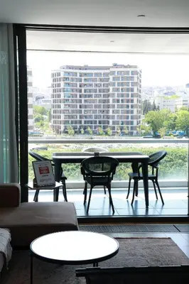 a room with a large window with a table and chairs at Lovely Two Bedroom Appartment Istanbul in Istanbul