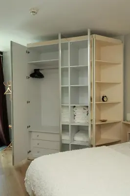 a white bedroom with a bed and white shelves at Lovely Two Bedroom Appartment Istanbul in Istanbul
