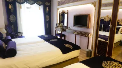 a hotel room with two beds and a mirror at Golden Marmara Hotel in Istanbul