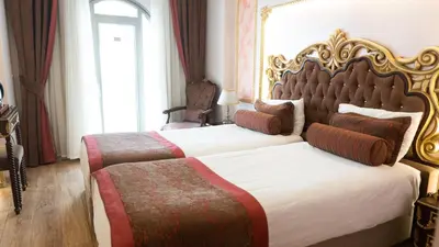 a bedroom with two beds with a large headboard at Golden Marmara Hotel in Istanbul
