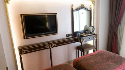 a room with a mirror and a tv on a wall at Golden Marmara Hotel in Istanbul