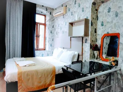a hotel room with a bed and a mirror at Ease Inn in Istanbul
