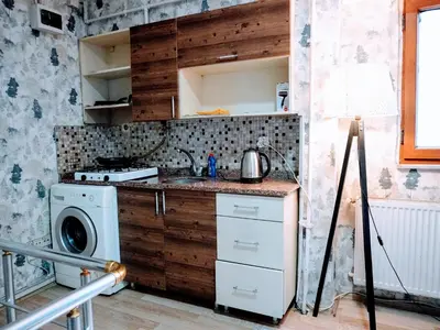 a kitchen with a sink and a washing machine at Ease Inn in Istanbul