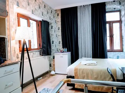 a bedroom with a bed and a lamp in it at Ease Inn in Istanbul