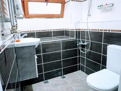 a bathroom with a shower and a toilet and a sink at Ease Inn in Istanbul