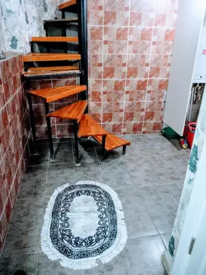 a rug on the floor in a room with a piano at Ease Inn in Istanbul
