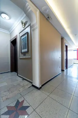 a hallway of a building with a pillar and a tile floor at OTEL ÜMIT İSTANBUL in Istanbul