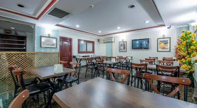 a dining room with tables and chairs in a restaurant at OTEL ÜMIT İSTANBUL in Istanbul