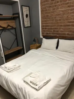 a white bed with two white towels on it at Kilit no 1 in Istanbul