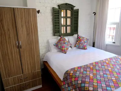 a bedroom with a bed and a wooden cabinet at Istanberry - Luna Apartments in Istanbul