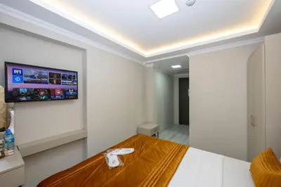 a room with a bed and a flat screen tv on the wall at SKYSTAR DELUXE HOTEL in Istanbul