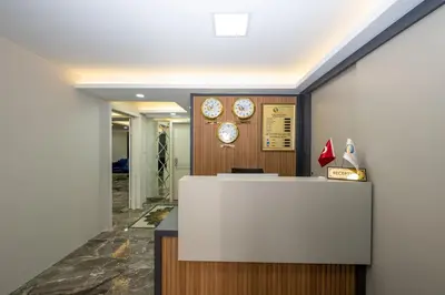 an office with a reception desk and clocks on the wall at SKYSTAR DELUXE HOTEL in Istanbul