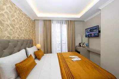 a hotel room with a large bed and a window at SKYSTAR DELUXE HOTEL in Istanbul