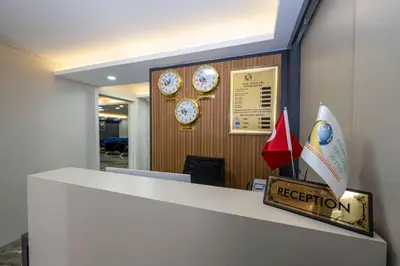 an office reception counter with clocks on the wall at SKYSTAR DELUXE HOTEL in Istanbul