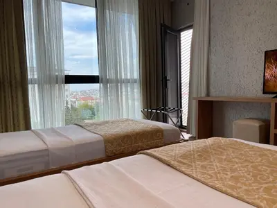 a hotel room with two beds and a large window at İNNPORT HOTEL in Gebze