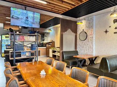a restaurant with tables and chairs and a tv at İNNPORT HOTEL in Gebze