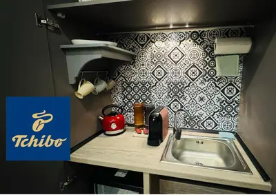 a kitchen with a sink and a tile wall at The House Company in Istanbul
