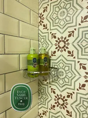 a bathroom with two soap bottles on a shelf on a wall at The House Company in Istanbul